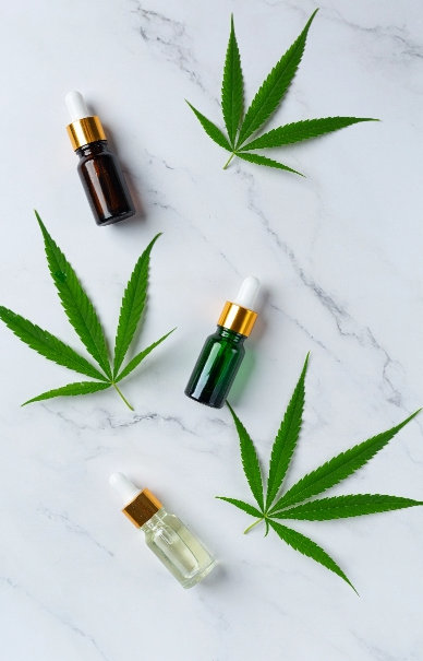 image of 3 cannabis leaves and 3 bottles of serum